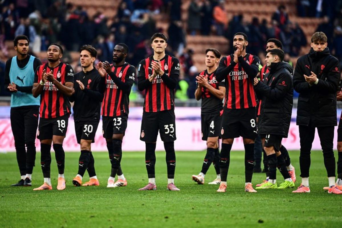 AC Milan players acknowledge their supporters at the end of the Italian Serie A football match between AC Milan and Sassuolo at the San Siro Stadium in Milan on December 14, 2025.  Piero CRUCIATTI / AFP