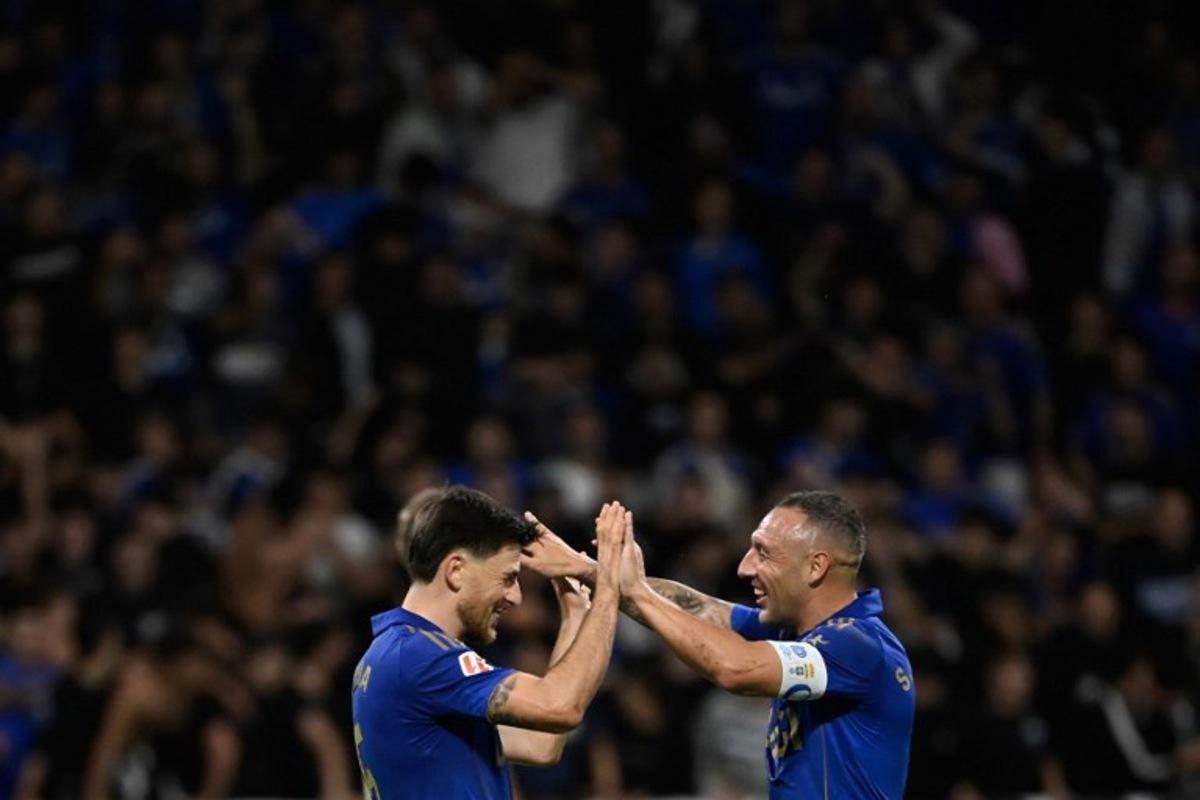 Real Oviedo's Spanish midfielder #05 Alberto Reina (L) celebrates with teammate Real Oviedo's Spanish midfielder #08 Santiago Cazorla after scoring their first goal during the Spanish league football match between Real Oviedo and FC Barcelona at the Carlos Tartiere stadium in Oviedo on September 25, 2025.  Miguel RIOPA / AFP