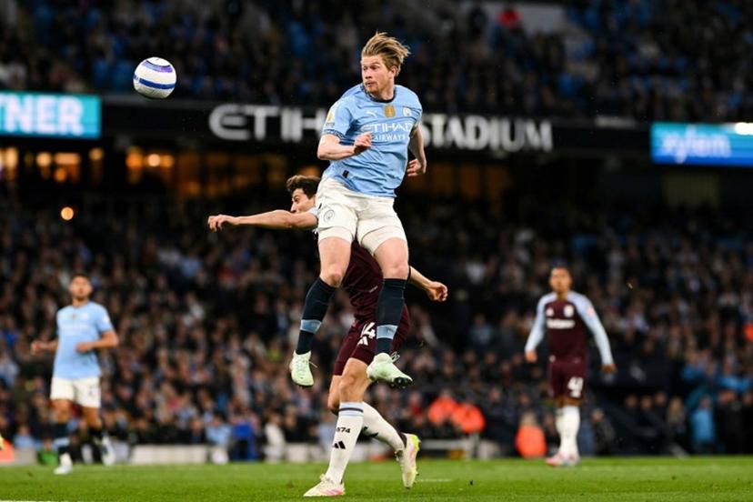 Manchester City's Belgian midfielder #17 Kevin De Bruyne heads the ball during the English Premier League football match between Manchester City and Aston Villa at the Etihad Stadium in Manchester, north west England, on April 22, 2025.  Oli SCARFF / AFP