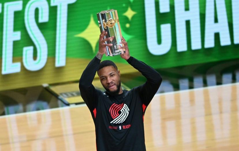 Basketball player Damian Lillard, of the Portland Trailblazers, holds up the trophy after winning the three point contest during NBA All-Star Weekend in Salt Lake City, Utah, February 18, 2023.   Patrick T. Fallon / AFP