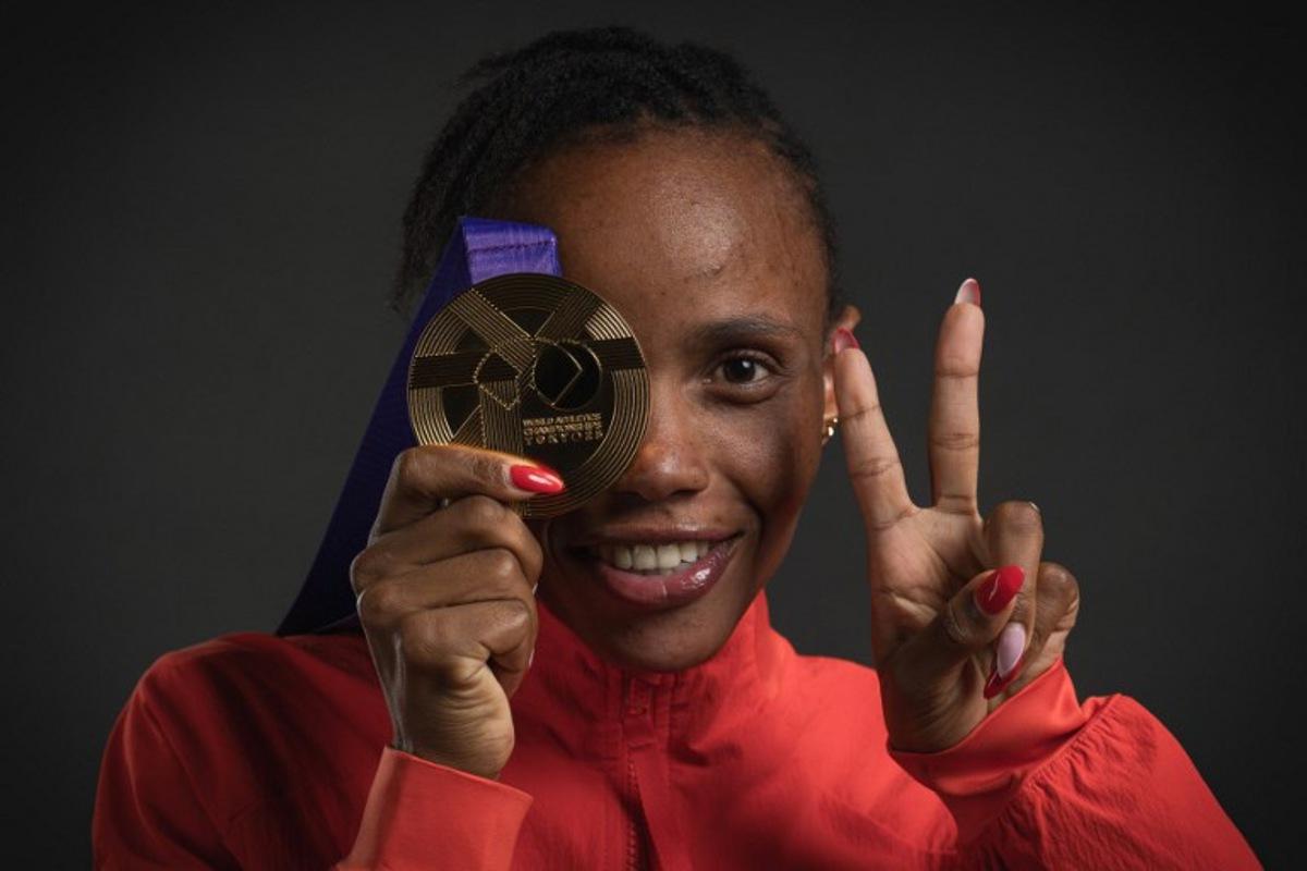 Gold medallist Kenya's athlete Beatrice Chebet poses for portraits after the women's 5000m final during a studio photo session on the sidelines of the World Athletics Championships in Tokyo on September 21, 2025.  Andrej ISAKOVIC / AFP