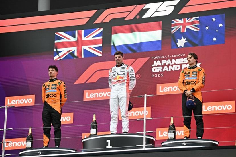 (L-R) Second-placed McLaren's British driver Lando Norris, winner Red Bull Racing's Dutch driver Max Verstappen, and third-placed McLaren's Australian driver Oscar Piastri celebrate on the podium after the Formula One Japanese Grand Prix at the Suzuka circuit in Suzuka, Mie prefecture, Japan on April 6, 2025.  Philip FONG / AFP