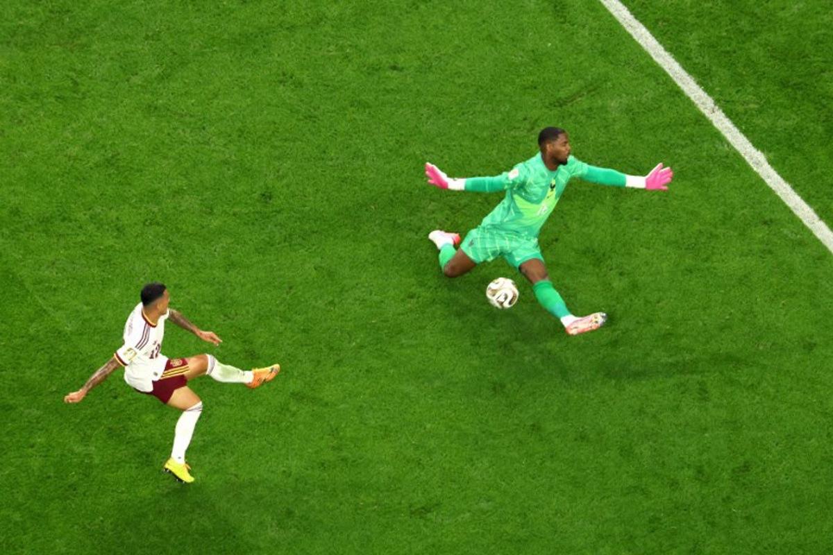 Spain's defender #12 Pedro Porro scores his team's second goal past France's goalkeeper #16 Mike Maignan during the 2026 World Cup football tournament semi-final match between France and Spain at the Dallas Stadium in Arlington on July 14, 2026.   Odd ANDERSEN / AFP