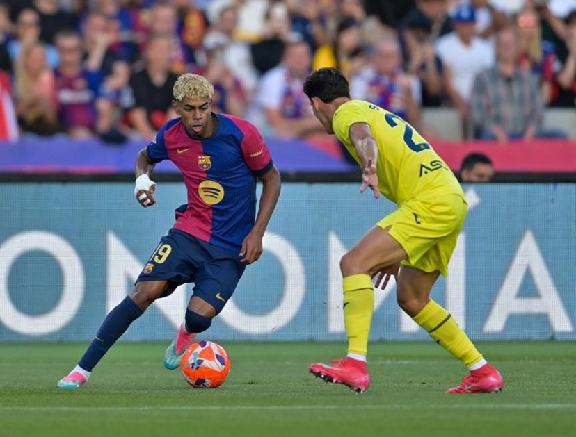 Villarreal's Spanish defender #23 Sergi Cardona (R) and Barcelona's Spanish forward #19 Lamine Yamal vie for the ball during the Spanish league football match between FC Barcelona and Villarreal CF at Estadi Olimpic Lluis Companys in Barcelona on May 18, 2025.  MANAURE QUINTERO / AFP