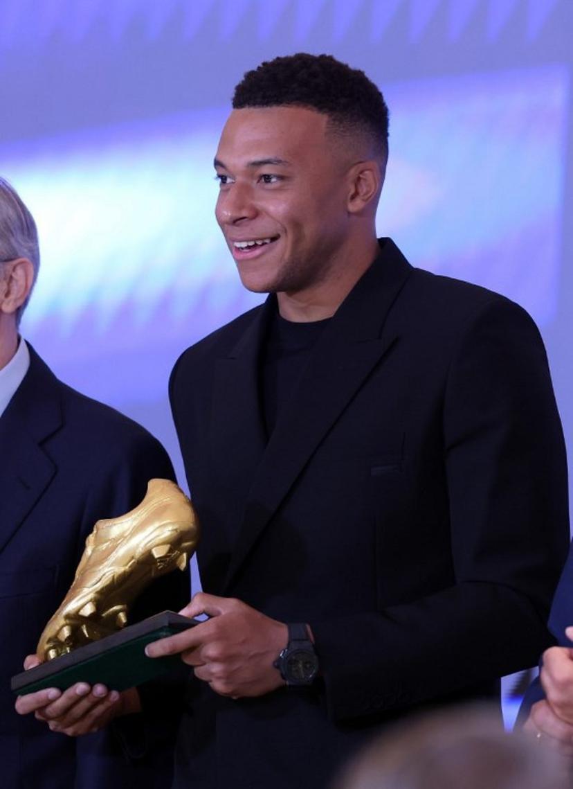 Real Madrid's French forward Kylian Mbappe smiles after receiving the 2024-25 European Golden Shoe award honoring the year's leading goalscorer during a ceremony at Santiago Bernabeu Stadium in Madrid on October 31, 2024.  Oscar DEL POZO / AFP