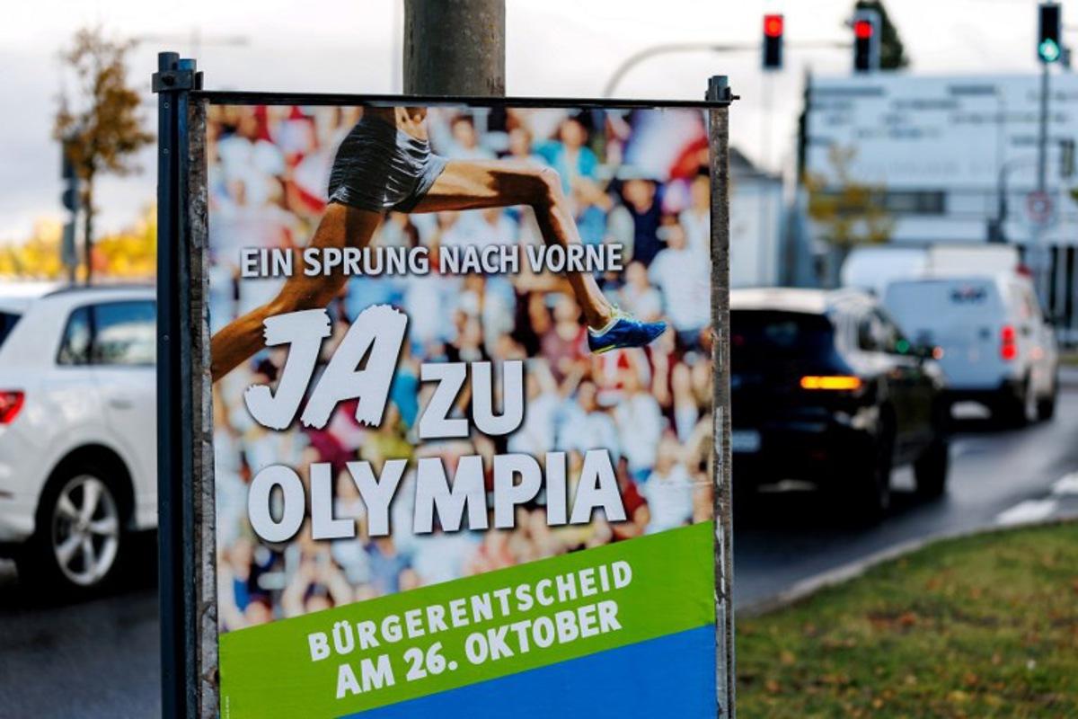 A photo taken on October 24, 2025 shows a placard with the lettering 'A jump ahead - Yes to the Olympics' in Munich, southern Germany, ahead of a citizens' decision on the bid of the city of Munich to organize the Olympic Summer Games from 2036.  On October 26, 2025, citizens of Munich will decide on the city's bid to organize the Olympic and Paralympic Summer Games in 2036, 2040 or 2044. Matthias BALK / AFP