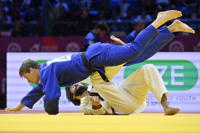 Azerbaijan's Zelim Tckaev (white) competes against Belgium's Matthias Casse in the men's under 81 kg quarter-final at the World Judo Championships in Baku on October 7, 2026.  Alexander NEMENOV / AFP