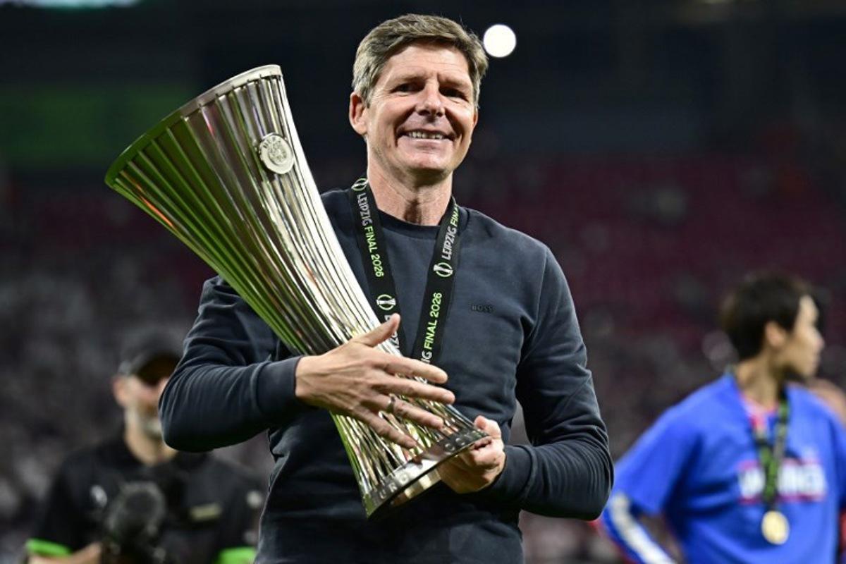 Crystal Palace's Austrian manager Oliver Glasner reacts as he holds the trophy after his team won the UEFA Conference League final football match between Crystal Palace FC and Rayo Vallecano de Madrid in Leipzig, eastern Germany, on May 27, 2026.    Tobias SCHWARZ / AFP
