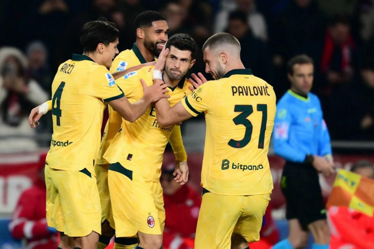 AC Milan's US forward #11 Christian Pulisic (C) celebrates scoring his team's second goal with teammates AC Milan's Italian midfielder #04 Samuele Ricci and AC Milan's Serbian defender #31 Strahinja Pavlovic during the Italian Serie A football match between Torino and AC Milan at the Allianz stadium in Turin, on December 8, 2025.  Marco BERTORELLO / AFP