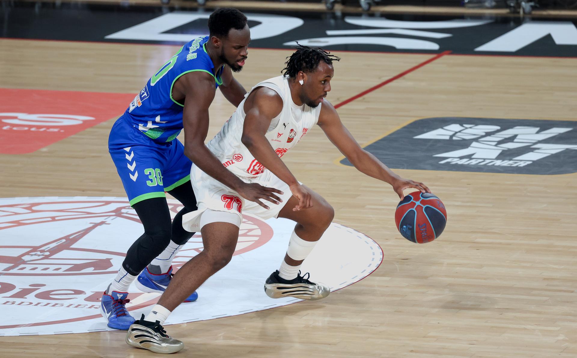 Mons' Tito Casero and Charleroi's Marlon Makwa fight for the ball during a basketball match between Spirou Charleroi and Union Mons-Hainaut, Tuesday 23 December 2025 in Charleroi, on day 13 of the 'BNXT League' Belgian and Dutch first division basket championships. BELGA PHOTO VIRGINIE LEFOUR