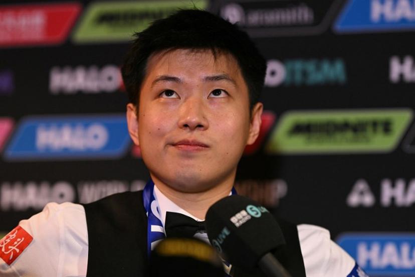 China's Zhao Xintong reacts at a press conference after victory over Wales' Mark Williams in the World Championship Snooker final at The Crucible in Sheffield, northern England on May 5, 2025.  Zhao Xintong became the first Chinese player to win the World Snooker Championship as the qualifier completed his stunning march to the title with a 18-12 victory against Mark Williams in the final on Monday. Oli SCARFF / AFP