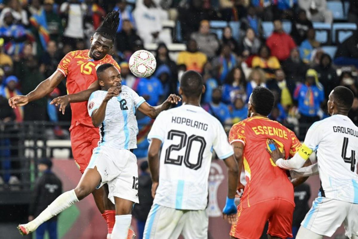 Democratic Republic Of Congo's defender #15 Rocky Bushiri and Botswana's defender #12 Mothusi Johnson vie during the Africa Cup of Nations (CAN) Group D football match between Botswana and Democratic Republic of Congo at El Madina Stadium in Rabat on December 30, 2025.   SEBASTIEN BOZON / AFP