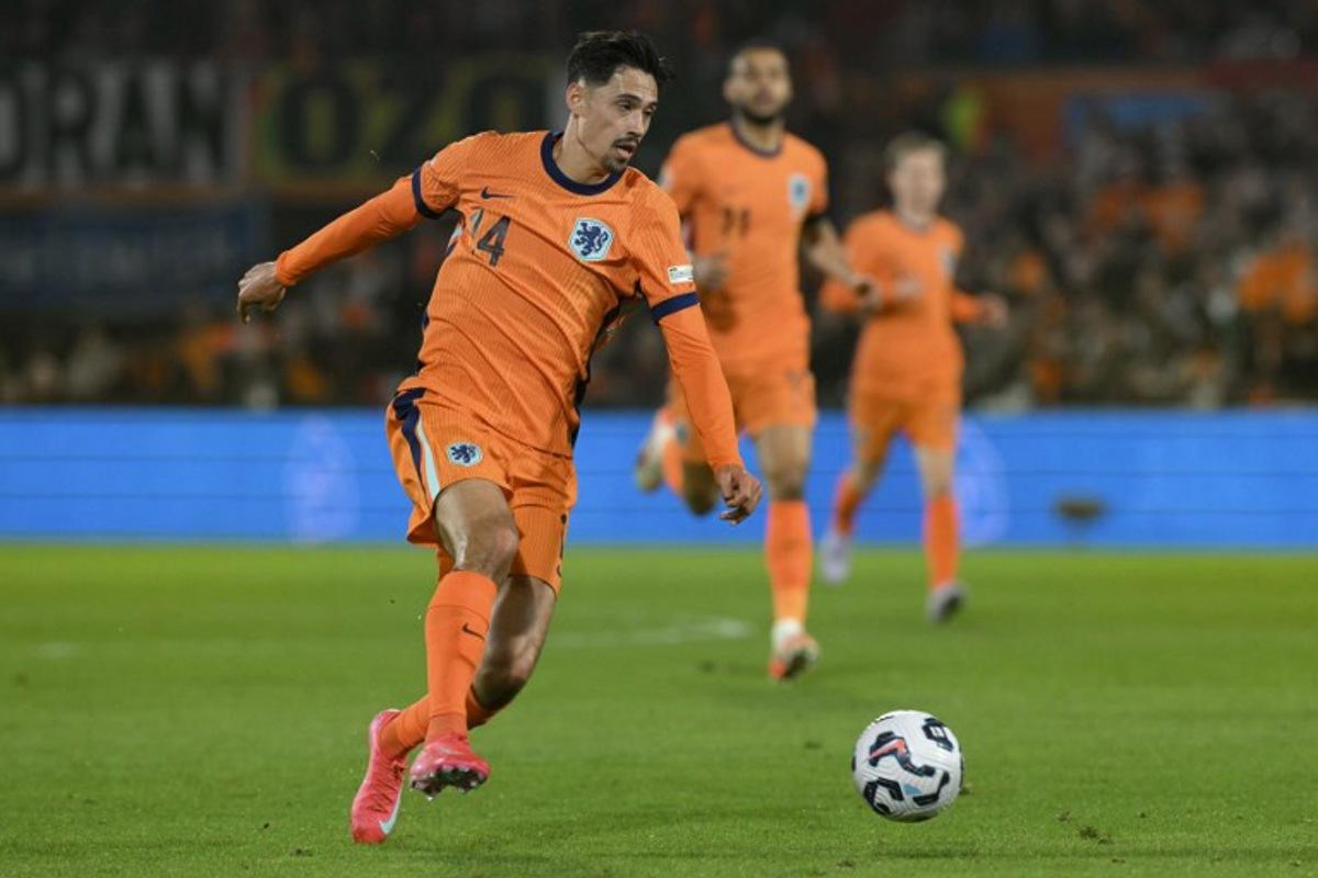 Netherlands' midfielder #14 Tijjani Reijnders controls the ball during the UEFA Nations League quarter-final first leg match between Netherlands and Spain at De Kuip stadium in Rotterdam, on March 20, 2025.  NICOLAS TUCAT / AFP