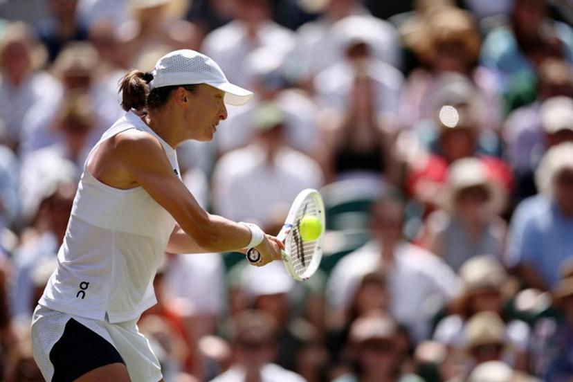 Poland's Iga Swiatek returns to Philippines' Alexandra Eala during their women's singles third round tennis match on the sixth day of the 2026 Wimbledon Championships at The All England Lawn Tennis and Croquet Club in Wimbledon, southwest London, on July 4, 2026.  Henry Nicholls / AFP
