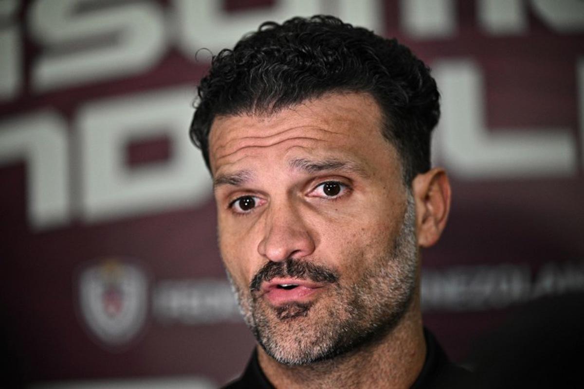 Venezuela's football head coach Oswaldo Vizcarrondo speaks with the press after an act to welcome the Venezuelan national football team that qualified for the U-17 World Cup Qatar-2025, in Caracas on April 14, 2025.  Federico PARRA / AFP