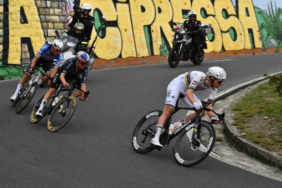 UAE Team Emirate's Slovenian rider Tadej Pogacar (R), Q36.5 Pro Cycling team's British rider Thomas Pidcock (C) and Alpecin-Deceuninck's Dutch rider Mathieu van der Poel ride down the Cipressa during the 117th Milan - Sanremo one-day classic cycling race, on March 21, 2026.  Marco BERTORELLO / AFP