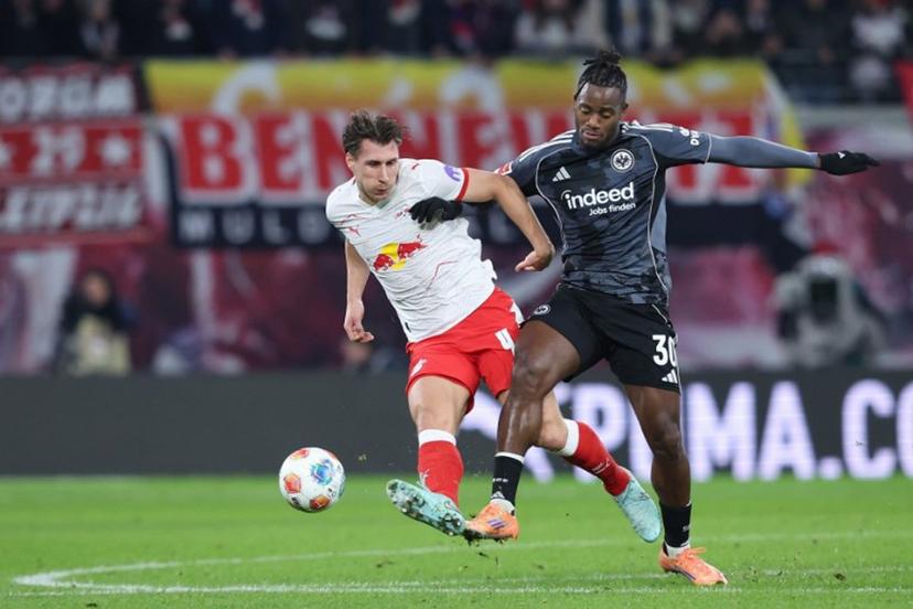 Leipzig's Hungarian defender #04 Willi Orban (L) and Frankfurt's Belgian forward #30 Michy Batshuayi vie for the ball during the German first division Bundesliga football match between RB Leipzig and Eintracht Frankfurt in Leipzig, eastern Germany, on December 6, 2025.  Ronny HARTMANN / AFP