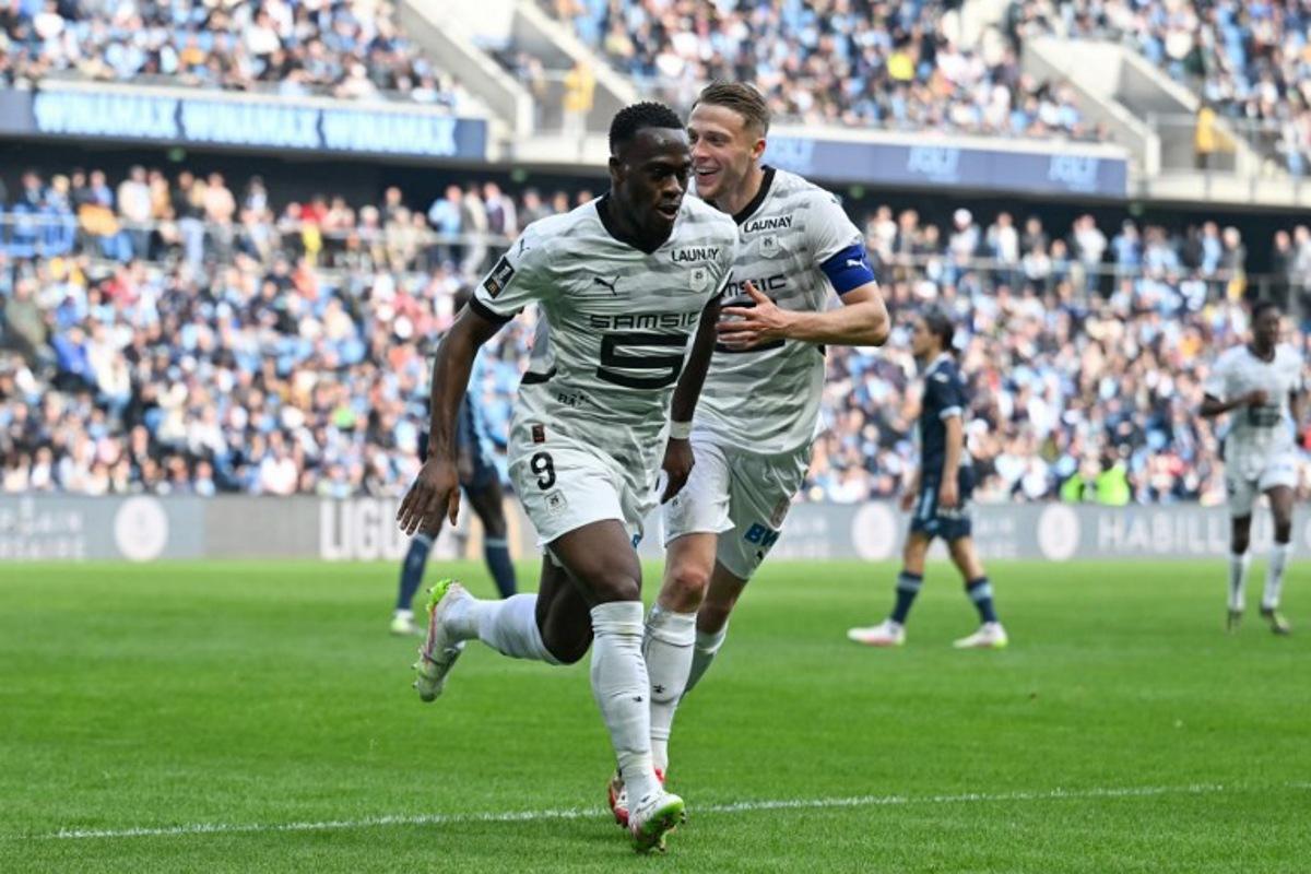 Rennes' French forward #09 Arnaud Kalimuendo (L) celebrates with his teammate Rennes' French defender #03 Adrien Truffert after scoring his team's third goal during the French L1 football match between Le Havre AC and Stade Rennais FC at The Stade Oceane in Le Havre, north-western France, on April 13, 2025. Rennes' French forward #09 Arnaud Kalimuendo celebrates after scoring the third goal during the L1 French football match between Le Havre AC (HAC) and Rennes at the Oceane Stadium, in Le Havre, Northwestern France, on April 13, 2025. Lou BENOIST / AFP