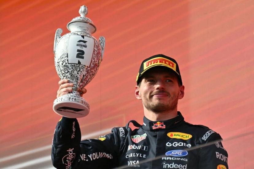 Second placed Red Bull Racing's Dutch driver Max Verstappen celebrates with the trophy on the podium after the Formula One Hungarian Grand Prix at the Hungaroring racetrack in Mogyorod near Budapest, Hungary, on July 26, 2026.  Andrej ISAKOVIC / AFP