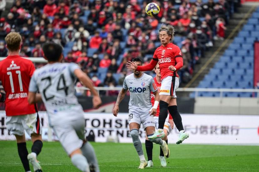 Urawa's forward Takuya Ogiwara (R) heads the ball during the J-League football match between Urawa Red Diamonds and Fagiano Okayama at Saitama stadium 2002 in Saitama city on March 8, 2025.  Yuichi YAMAZAKI / AFP