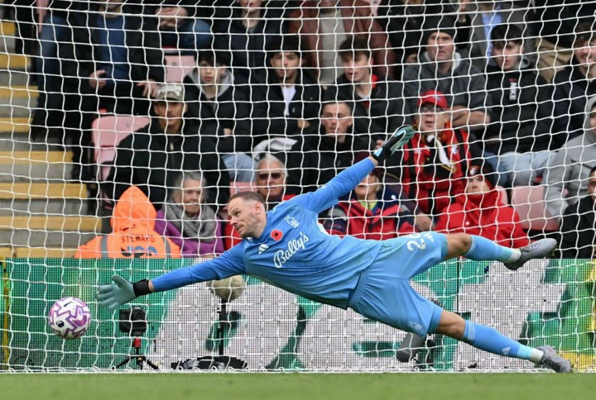 Nottingham Forest's Belgian goalkeeper #26 Matz Sels dives but can't get down quick enough to stop the shot by Bournemouth's French striker #22 Eli Junior Kroupi for Bournemouth's second goal 2-0 during the English Premier League football match between Bournemouth and Nottingham Forest at the Vitality Stadium in Bournemouth, southern England on October 26, 2025.  Glyn KIRK / AFP