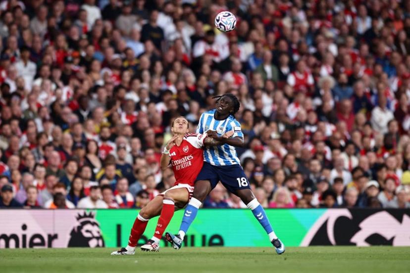 Arsenal's Italian defender #33 Riccardo Calafiori battles for the ball with Coventry City's French midfielder #18 Loum Tchaouna during the English Premier League football match between Arsenal and Coventry City at the Emirates Stadium in London on August 21, 2026.   Henry NICHOLLS / AFP