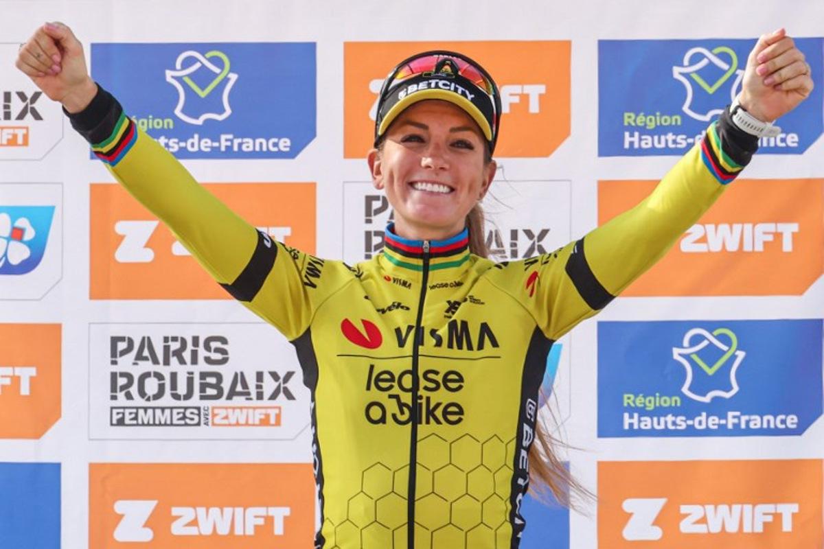 First placed Team Visma-Lease a Bike's French rider Pauline Ferrand Prevot celebrates on the podium of the fifth edition of the Paris-Roubaix women's race, 148,5 km between Denain and Roubaix, northern France on April 12, 2025.  Francois LO PRESTI / AFP
