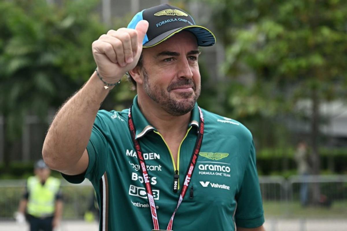 Aston Martin's Spanish driver Fernando Alonso gestures to fans before the first practice session ahead of the Formula One Singapore Grand Prix night race at the Marina Bay Street Circuit in Singapore on October 3, 2025.  Lillian SUWANRUMPHA / AFP