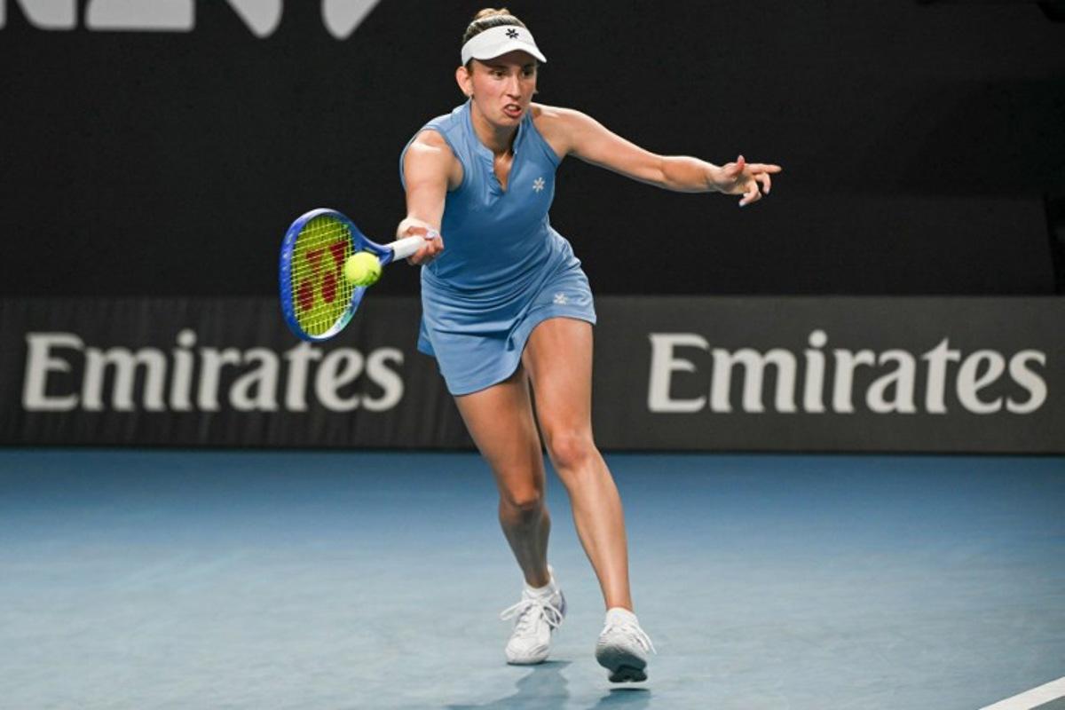 Belgium's Elise Mertens hits a return against Thailand's Lanlana Tararudee during their women's singles match on day two of the Australian Open tennis tournament in Melbourne on January 19, 2026.  Paul Crock / AFP