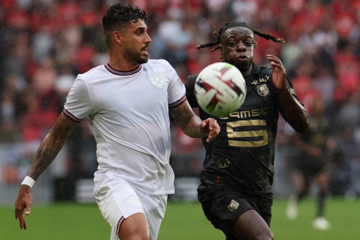 Rennes' Belgian forward Jeremy Doku (R) fights for the ball with West Ham United's Italian defender Emerson Palmieri during the pre-season friendly football match between Rennes and West Ham United FC at the Roazhon Park stadium in Rennes, western France, on July 29, 2023.   Fred TANNEAU / AFP