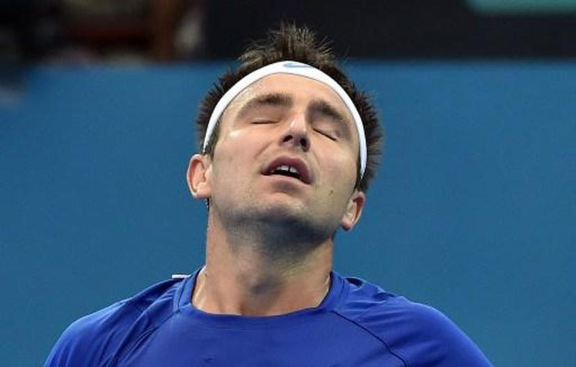 Marinko Matosevic of Australia reacts while playing against Steve Johnson of the US during their men's singles match on day three of the Brisbane International tennis tournament in Brisbane on January 6, 2015.   AFP PHOTO / Saeed KHAN IMAGE RESTRICTED TO EDITORIAL USE - STRICTLY NO COMMERCIAL USE IMAGE RESTRICTED TO EDITORIAL USE - STRICTLY NO COMMERCIAL USE

