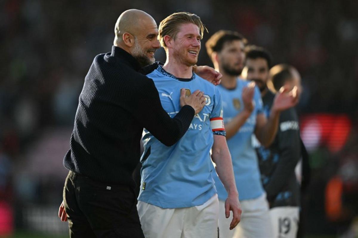 Manchester City's Spanish manager Pep Guardiola (L) celebrates with Manchester City's Belgian midfielder #17 Kevin De Bruyne (R) after the English FA Cup quarter-final football match between Bournemouth and Manchester City at the Vitality Stadium in Bournemouth, on the south coast of England on March 30, 2025. City won the game 2-1. JUSTIN TALLIS / AFP