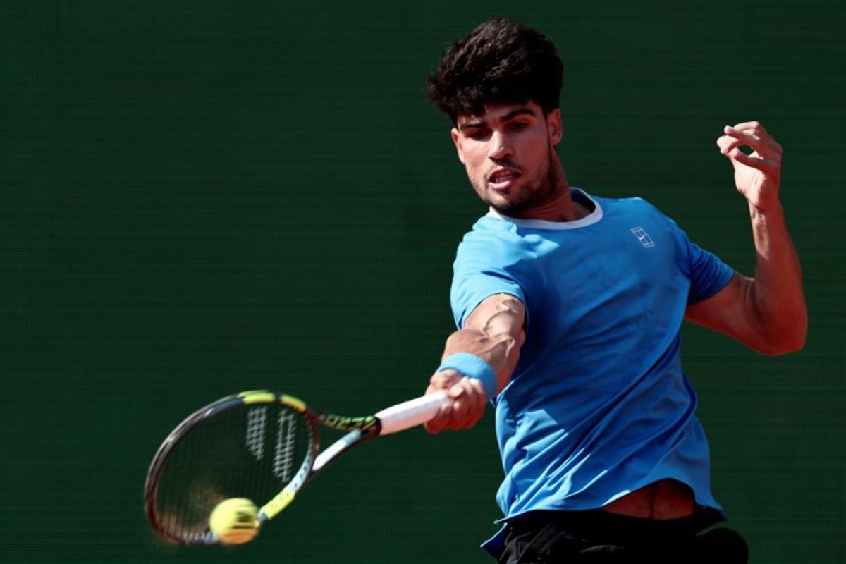 Spain's Carlos Alcaraz plays a forehand return to Monaco's Valentin Vacherot during the Monte Carlo ATP Masters Series Tournament semi-final tennis match on Court Rainier III at the Monte-Carlo Country Club in Roquebrune-Cap-Martin, south-eastern France on April 11, 2026.  Thibaud MORITZ / AFP