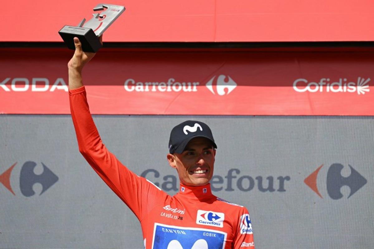 Team Movistar's Spanish rider Enric Mas celebrates on the podium retaining the overall ranking leader's red jersey after 16th stage of the Vuelta a Espana 2026 cycling tour, a 181,1 km race between Cortegana and the Monastery of Santa Maria de la Rabida in Palos de la Frontera, on September 8, 2026.   JORGE GUERRERO / AFP