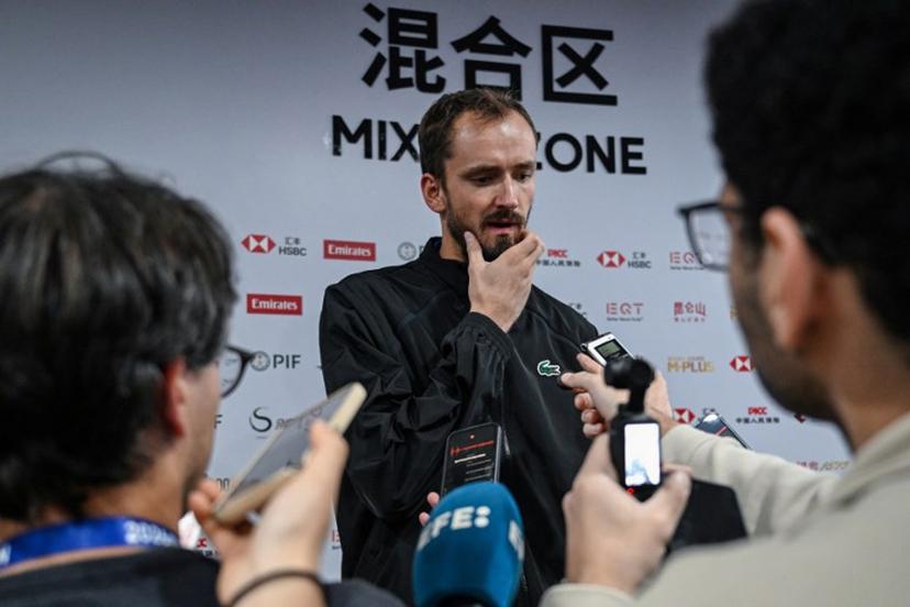 Russia's Daniil Medvedev (C) speaks to media after he was disqualified for hitting a ball into the stands, injuring a spectator, during the men's singles semi-final against Serbia's Novak Djokovic at the China Open tennis tournament in Beijing on October 5, 2026.  GREG BAKER / AFP