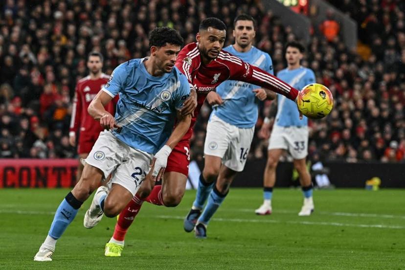 Manchester City's Portuguese midfielder #27 Matheus Nunes (L) defends against Liverpool's Dutch striker #18 Cody Gakpo (2nd L) during the English Premier League football match between Liverpool and Manchester City at Anfield in Liverpool, north west England on February 8, 2026.  Paul ELLIS / AFP