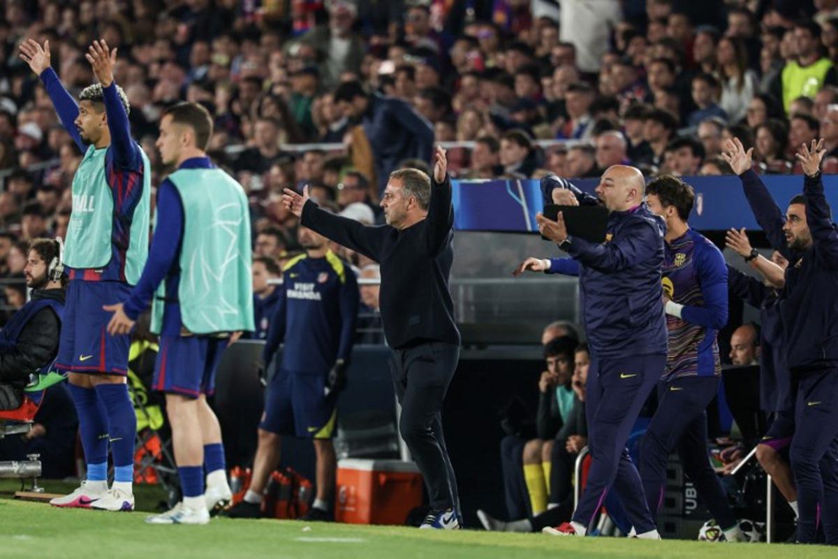 Barcelona's German coach Hans-Dieter Flick (C) gestures during the UEFA Champions League quarter final first leg football match between FC Barcelona and Club Atletico de Madrid at Camp Nou Stadium in Barcelona on April 8, 2026.  Lluis GENE / AFP