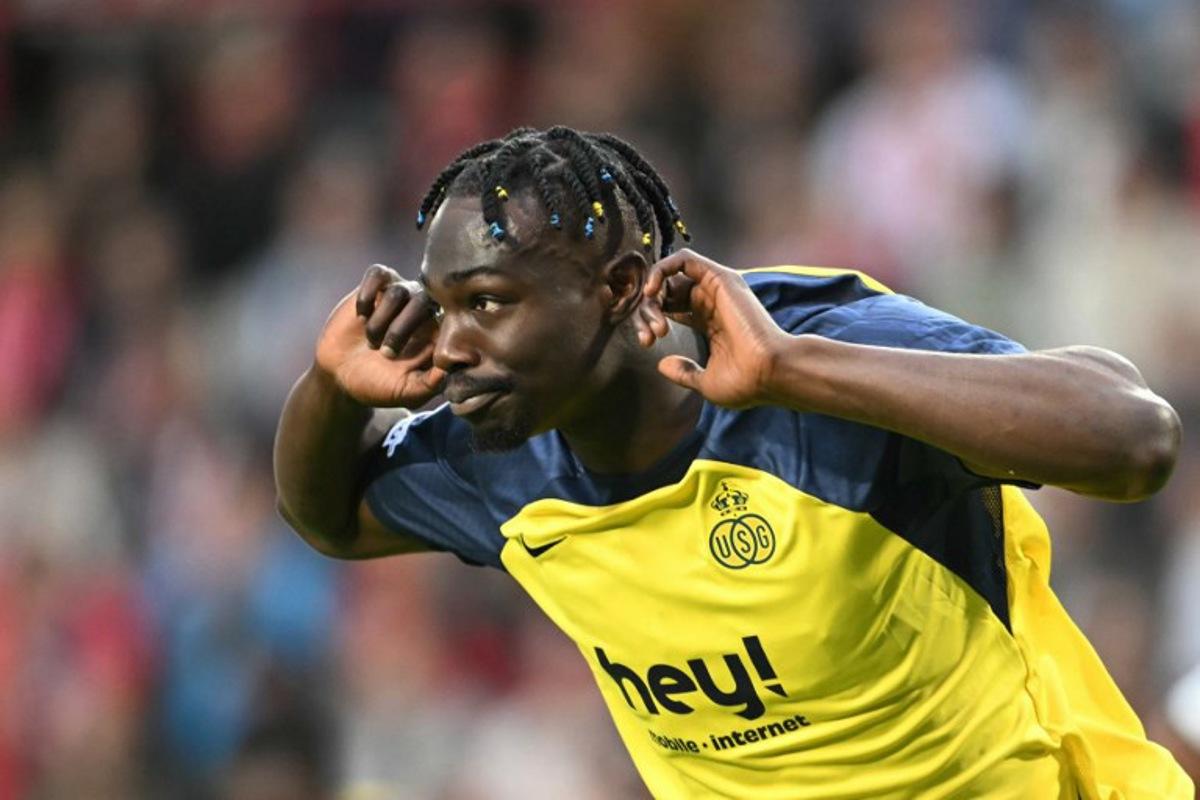Union's Canadian forward #12 Promise David celebrates scoring his team's first goal from the penalty spot during the UEFA Champions League first round day 1 football match between PSV Eindhoven and Union Saint-Gilloise at the Philips Stadium, in Eindhoven on September 16, 2025.   NICOLAS TUCAT / AFP
