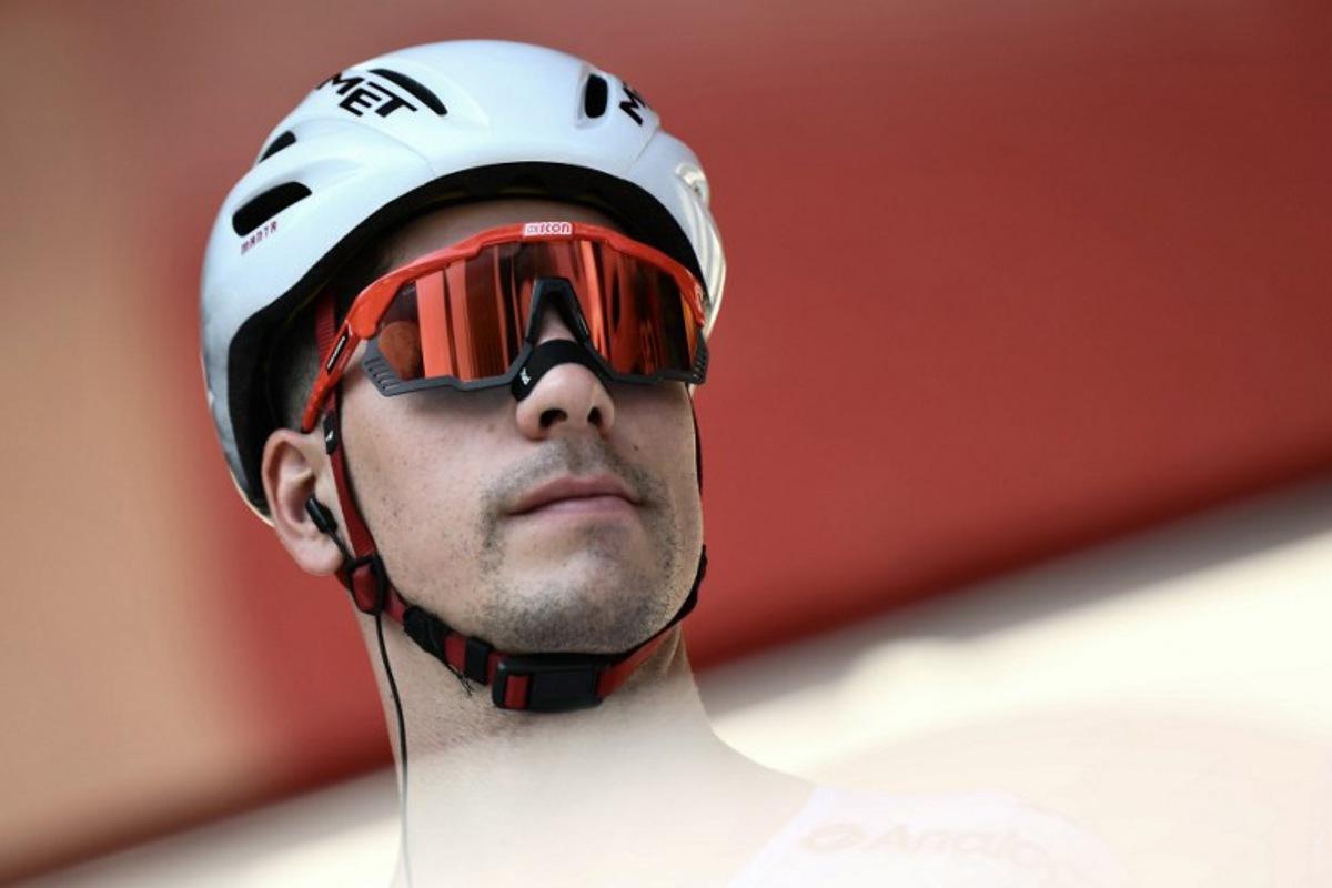 Team UAE's Portuguese rider Joao Almeida is presented on stage before the start of the Vuelta a Espana, a 183 km race between Torino - Reggia di Venaria and Novara, in Italy's Piemonte region, on August 23, 2025.    Marco BERTORELLO / AFP