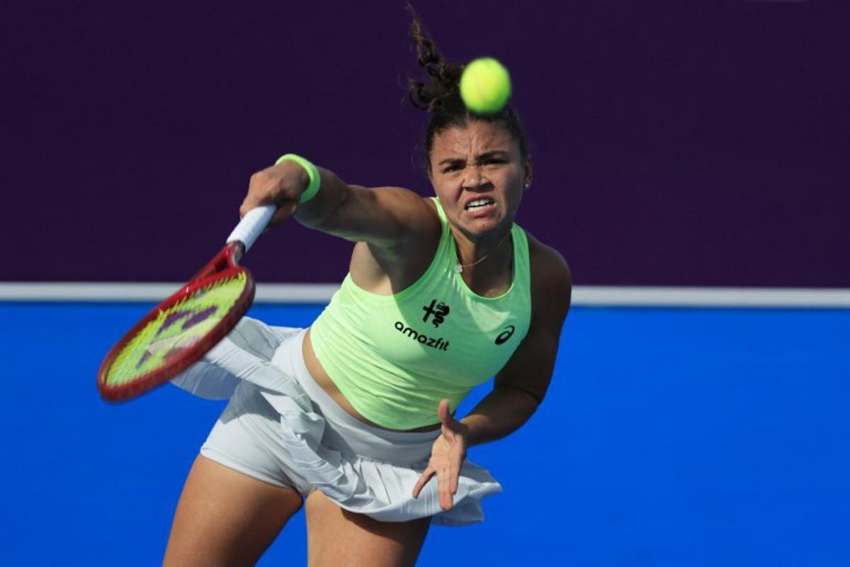 Italy's Jasmine Paolini serves against Greece's Maria Sakkari during their women's singles match at the Qatar Open tennis tournament in Doha on February 10, 2026.  Karim JAAFAR / AFP