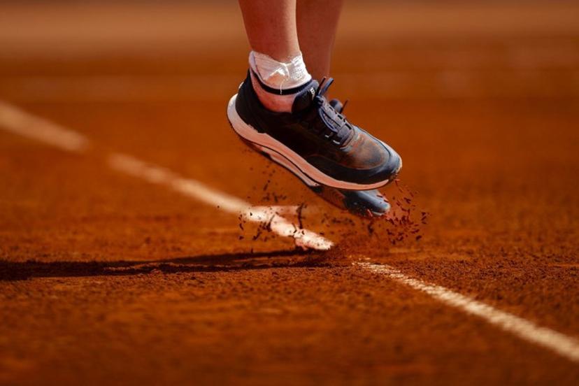 A photo shows the shoes of France's Leolia Jeanjean as she hits a return in her women's singles match against Hungary's Amarissa Kiara Toth during the Billie Jean King Cup play-offs between France and Hungary, at Oeiras outskirts of Lisbon, on April 10, 2026.  FILIPE AMORIM / AFP