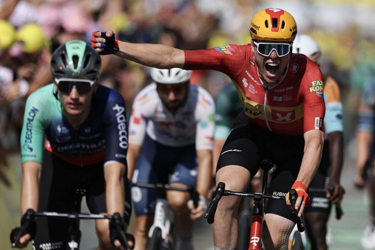 Uno-X Mobility team's Norwegian rider Soren Waerenskjold cycles to the finish line to win the 11th stage of the 113th edition of the Tour de France cycling race, 161,3 km between Vichy and Nevers in central France, on July 15, 2026.  Anne-Christine POUJOULAT / AFP