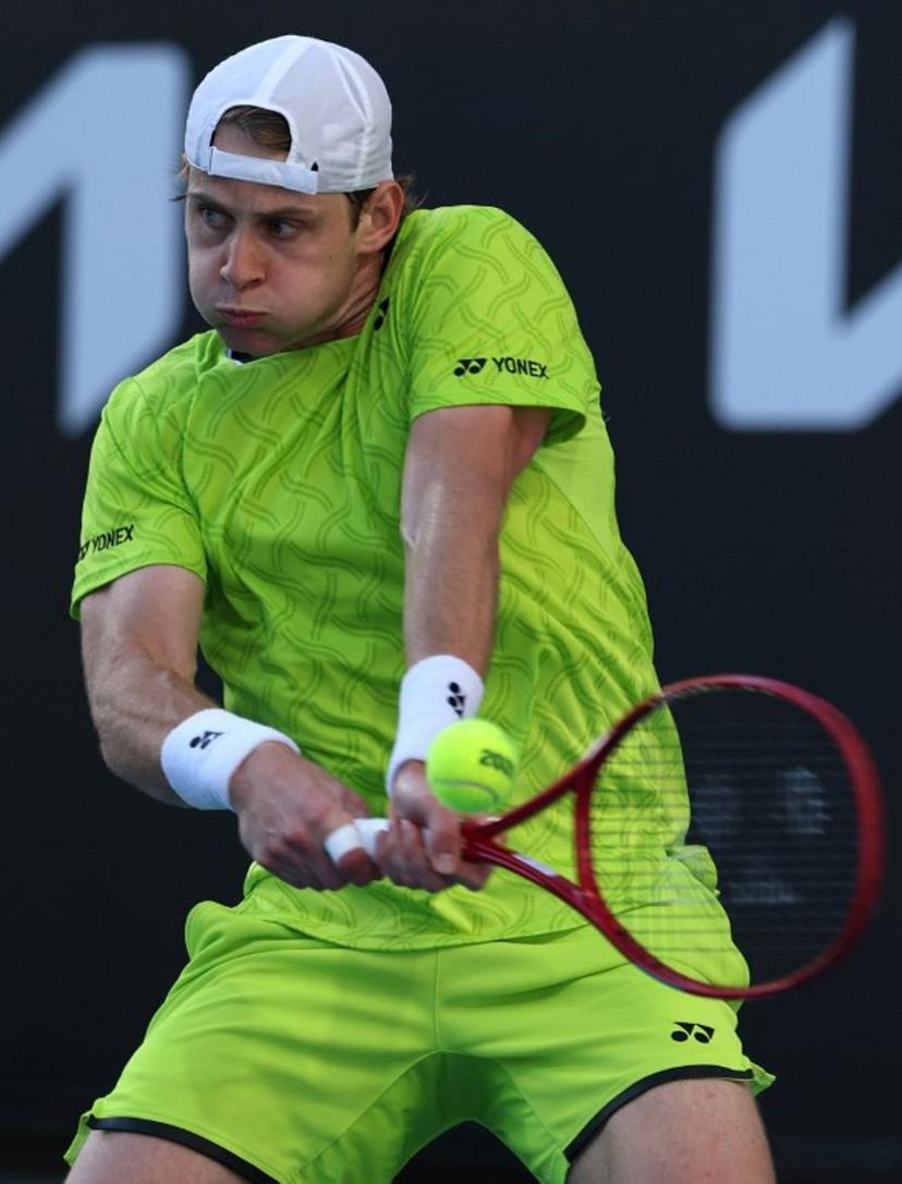 Belgium's Zizou Bergs hits a shot against Poland's Hubert Hurkacz during their men's singles match on day three of the Australian Open tennis tournament in Melbourne on January 20, 2026.  IZHAR KHAN / AFP