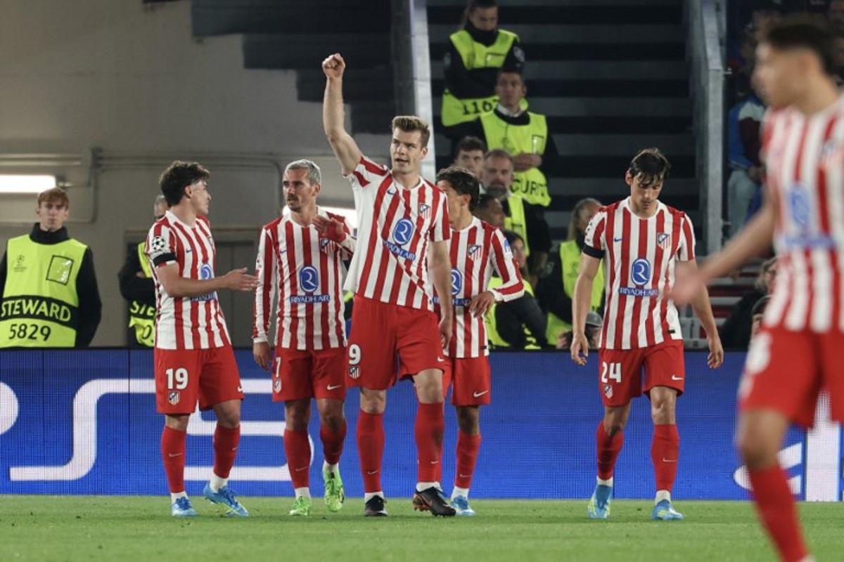 Atletico Madrid's Norwegian forward #09 Alexander Sorloth (C) celebrates scoring his team's second goal during the UEFA Champions League quarter final first leg football match between FC Barcelona and Club Atletico de Madrid at Camp Nou Stadium in Barcelona on April 8, 2026.  Lluis GENE / AFP