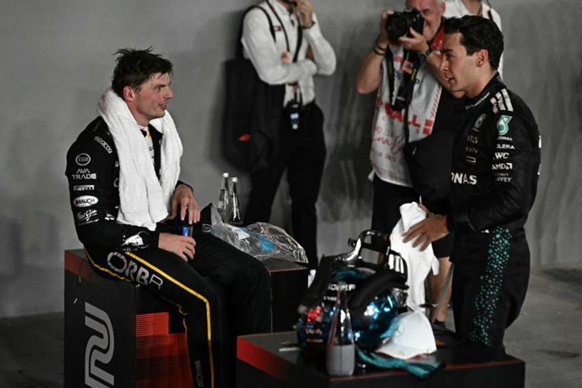 First-placed Mercedes' British driver George Russell (R) and second-placed Red Bull Racing's Dutch driver Max Verstappen react after the Formula One Singapore Grand Prix night race at the Marina Bay Street Circuit in Singapore on October 5, 2025.  Lillian SUWANRUMPHA / AFP