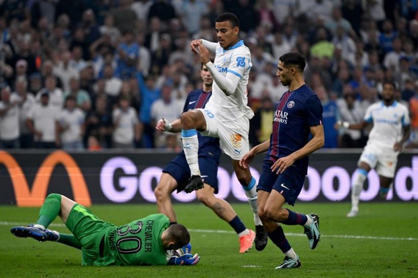 Paris Saint-Germain's French goalkeeper #30 Lucas Chevalier (L) grabs the ball in front of Marseille's English forward #10 Mason Greenwood during the French L1 football match between Olympique de Marseille (OM) and Paris Saint-Germain (PSG) at the Velodrome stadium in Marseille on September 22, 2025.  Miguel MEDINA / AFP