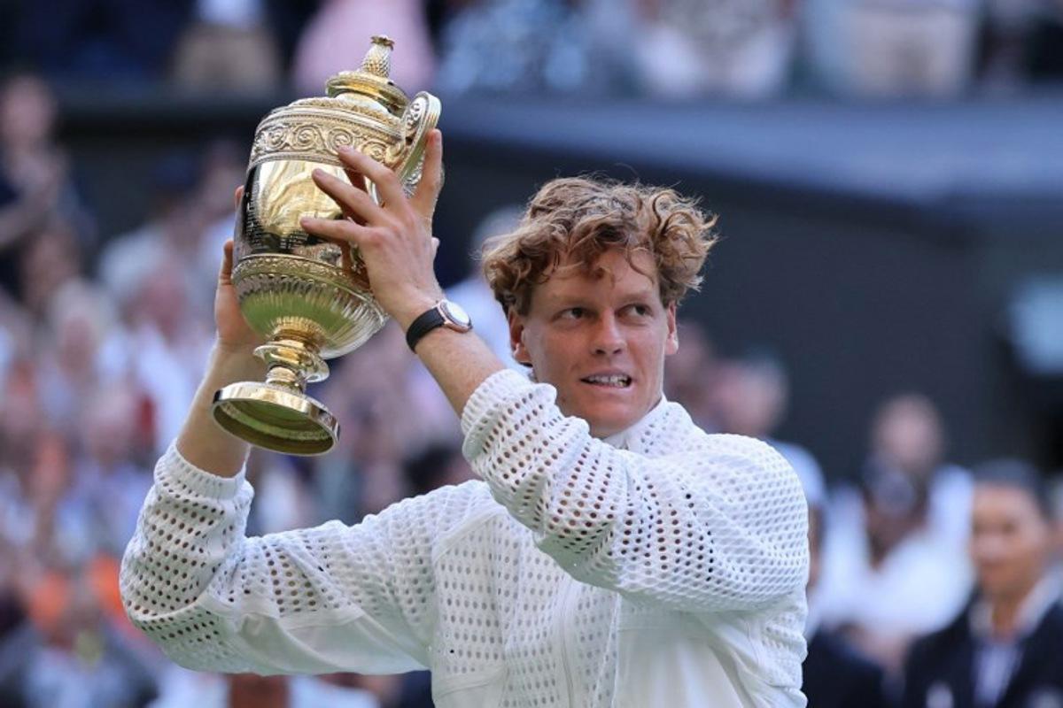 Italy's Jannik Sinner poses with the Gentleman's Singles trophy after his victory against Germany's Alexander Zverev at the end of their men's singles final tennis match on the last day of the 2026 Wimbledon Championships at The All England Lawn Tennis and Croquet Club in Wimbledon, southwest London, on July 12, 2026.  Henry NICHOLLS / AFP