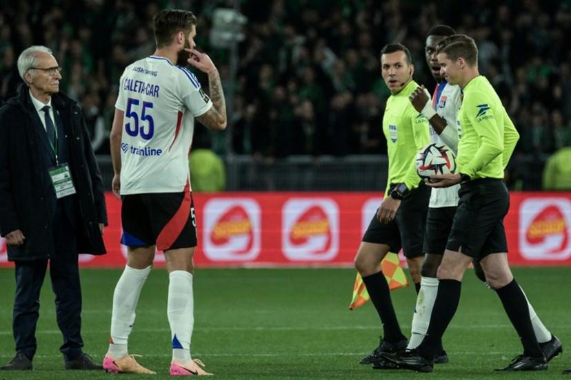 French referee Mehdi Rahmoun (3rd R) looks on during the French L1 football match between AS Saint-Etienne and Olympique Lyonnais (OL) after the match was suspended at the Geoffroy-Guichard Stadium in Saint-Etienne, central France on April 20, 2025. The derby between Saint-Etienne and Lyon was interrupted on Sunday evening just before half-time (45th) after a projectile thrown from the stands hit touchline referee Mehdi Rahmouni on the head. Lyon fans have been banned from travelling to this derby, which has often been marked by incidents. JEAN-PHILIPPE KSIAZEK / AFP