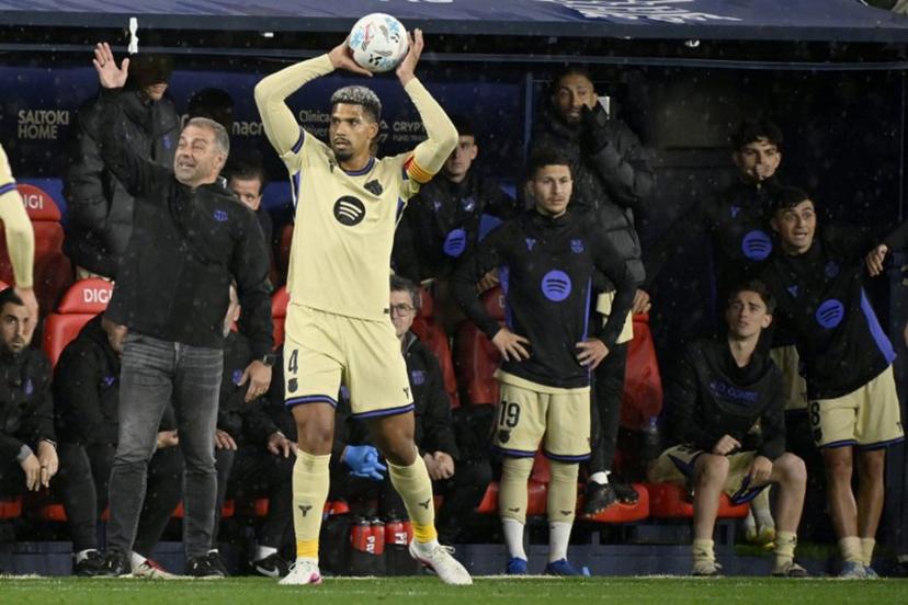 Barcelona's German coach Hans-Dieter Flick (L) gestures as Barcelona's Uruguayan defender #04 Ronald Federico Araujo da Silva takes a throw-in during the Spanish league football match between CA Osasuna and FC Barcelona at El Sadar Stadium in Pamplona on May 2, 2026.  ANDER GILLENEA / AFP