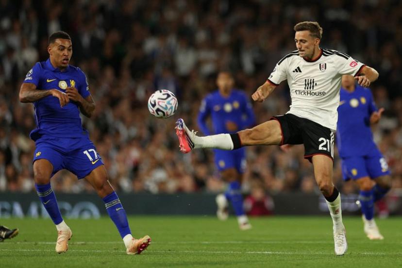 Fulham's Belgian defender #21 Timothy Castagne (R) vies with Chelsea's English midfielder #17 Morgan Rogers (L) during the English Premier League football match between Fulham and Chelsea at Craven Cottage in London on August 24, 2026.  Adrian Dennis / AFP
